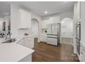 Bright kitchen with white cabinets, stainless steel appliances, and dark hardwood floors at 3615 Slider Ter, Indian Land, SC 29720