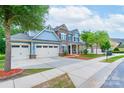Inviting two-story home with three-car garage, manicured lawn, and traditional architectural details at 3666 Jacinta Ct, Tega Cay, SC 29708