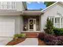 Inviting front porch with stone accents and a decorative wreath on the front door at 4101 Fairway Downs Ct # 9, Charlotte, NC 28277