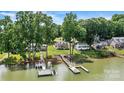 Waterfront homes with private docks on a serene lake, surrounded by lush trees at 4920 Longfield St, Claremont, NC 28610