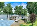 Lakeside cottage with a deck overlooking the water and a covered parking area at 4920 Longfield St, Claremont, NC 28610