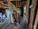 Interior view with exposed framing, electrical wiring, and scattered building supplies at 5040 Fairview Church Rd, Lincolnton, NC 28092