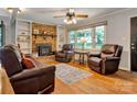 Inviting living room with a brick fireplace, built-in shelves, and hardwood floors at 511 Apple Ln, Bessemer City, NC 28016