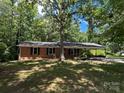 Charming brick home with attached carport nestled among mature trees at 511 Evelyn Ave, Kannapolis, NC 28083