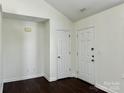 Inviting entryway with wood flooring, a door to the exterior, and a coat closet at 710 Woodington Ln, Charlotte, NC 28214