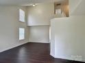 Bright living room with soaring ceilings, large windows, and hardwood floors at 710 Woodington Ln, Charlotte, NC 28214