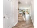Inviting entryway with hardwood floors, staircase, and view into the living area at 724 Little Bluestem Dr, Lake Wylie, SC 29710