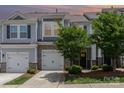 Beautiful townhome with stone details, a two-car garage, and well-maintained landscaping at 724 Little Bluestem Dr, Lake Wylie, SC 29710