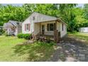 A quaint, single-story home with a small front porch and a well-maintained lawn at 730 Marble St, Charlotte, NC 28208