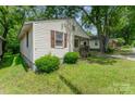A side view of a single-story home with simple landscaping and classic siding at 730 Marble St, Charlotte, NC 28208