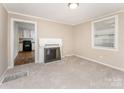 Bright living room with fireplace, carpet, and view of kitchen at 730 Marble St, Charlotte, NC 28208