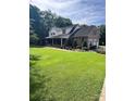 Beautiful two-story brick home featuring manicured lawn, lush landscaping, and an attached garage at 803 Freeman Rd, Concord, NC 28025