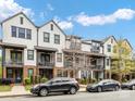 Attractive exteriors of townhomes featuring balconies, brick accents, and lush landscaping along the street at 933 E 36Th St, Charlotte, NC 28205