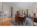 Formal dining room boasting hardwood floors, a chandelier, and access to the foyer at 10317 Clubhouse View Ln, Mint Hill, NC 28227