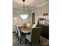 Elegant dining room featuring a modern chandelier and stylish decor with seating for six at 104 Bunker Way # 1001, Mooresville, NC 28117