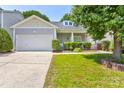 Well-maintained single-story house with attached garage, manicured lawn, and inviting front porch at 10927 Chrudan Dr, Charlotte, NC 28262