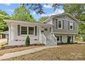 Inviting two-story home boasts a mix of modern and traditional architectural styles with manicured landscaping at 1814 Brookdale Ave, Charlotte, NC 28210
