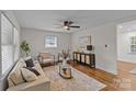 Bright living room features hardwood floors, modern decor, a ceiling fan and ample natural light at 1814 Brookdale Ave, Charlotte, NC 28210