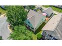 Aerial view of a light blue home with a pink umbrella in the backyard at 186 Gresham Ln, Mooresville, NC 28117