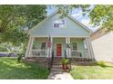 Inviting two-story home with light blue siding, red door, front porch, and manicured lawn at 186 Gresham Ln, Mooresville, NC 28117
