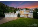 Stunning modern home with three-car garage and manicured lawn at twilight at 188 Blarney Rd, Mooresville, NC 28117