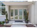 Elegant front entrance with double glass doors, stone accents, and decorative potted plants at 188 Blarney Rd, Mooresville, NC 28117