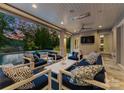 Covered patio with comfortable seating and outdoor television for entertaining at 188 Blarney Rd, Mooresville, NC 28117