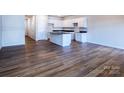 A spacious living room boasts wood flooring and connects to the kitchen area at 2541 Ruby Dixon Crossing Dr # 18, Gastonia, NC 28056