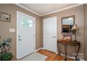 Inviting foyer featuring hardwood floors, a stylish mirror, and a well-lit entrance to welcome guests at 2865 Water Plant Rd, Maiden, NC 28650