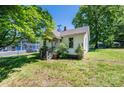 The home's exterior is framed by lush greenery, adding to its curb appeal and inviting atmosphere at 3042 N Oxford St, Claremont, NC 28610