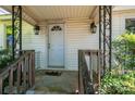 A quaint front porch welcomes visitors with decorative ironwork and a classic white door at 3042 N Oxford St, Claremont, NC 28610