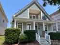 Charming two-story home featuring a welcoming front porch with stone accents and a second-story balcony at 4135 Twenty Grand Dr, Indian Trail, NC 28079