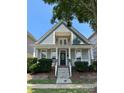 Charming two-story home featuring a welcoming front porch with stone accents and a second-story balcony at 4135 Twenty Grand Dr, Indian Trail, NC 28079