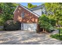 Spacious two-car garage with an extended driveway and well-maintained landscaping at 4389 Enchantment Cove Ln, Charlotte, NC 28216