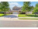 Attractive two-story home with a well-maintained lawn, brick facade, and convenient two-car garage at 4935 Norman Park Pl, Clover, SC 29710