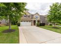 Charming two-story home featuring a spacious driveway, attached garage, and landscaped front yard at 4935 Norman Park Pl, Clover, SC 29710