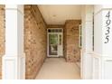 Inviting front porch featuring brick columns and a storm door with easy access to the house number at 4935 Norman Park Pl, Clover, SC 29710