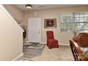 Entryway showcasing a neutral color palette, a staircase, and an interior door with sidelight at 5011 Blue Stream Ln, Indian Trail, NC 28079