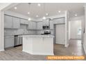 Modern kitchen with gray cabinets, granite countertops, stainless steel appliances, and a center island at 6005 Jasmine Branch Rd, Charlotte, NC 28216