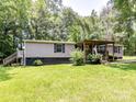 Exterior shot of single story home with covered porch and manicured yard at 615 Hawley Rd, McConnells, SC 29726