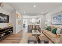 Inviting living room features hardwood floors, neutral walls, and an open layout with lots of natural light at 6423 Mallow Crossing Ln, Charlotte, NC 28213