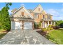 Attractive two-story home featuring a brick facade, manicured lawn, and a spacious driveway at 6430 Stirling Ln, Indian Land, SC 29707