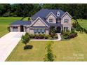 Stunning two-story brick home with lush landscaping, offering great curb appeal and a spacious layout at 720 Cavesson Way, Monroe, NC 28110