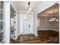 Inviting foyer with hardwood floors, a stylish pendant light, and glass-paneled doors, creating a bright entrance at 720 Cavesson Way, Monroe, NC 28110