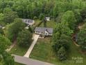 Aerial view of the home showcasing its location amidst lush greenery, with a long driveway at 730 Cove Rd, Gastonia, NC 28052