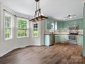 A well lit kitchen and dining space showcasing stainless steel appliances and hardwood floors at 730 Cove Rd, Gastonia, NC 28052