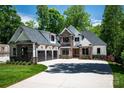 Lovely home with a three car garage, beautiful stonework, and a well-kept lawn at 7703 Juniper Ln, Denver, NC 28037