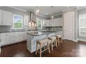 Modern kitchen featuring a granite island with bar seating, pendant lighting, and stainless steel appliances at 859 Academy St, Charlotte, NC 28205