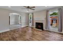 Bright living room featuring a fireplace, large windows, hardwood floors, and neutral color palette at 111 E Church St, Stanley, NC 28164