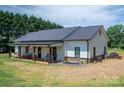 Well-maintained home with a metal roof, white siding, and a covered porch perfect for outdoor relaxing at 1138 Zeb Haynes Rd, Maiden, NC 28650